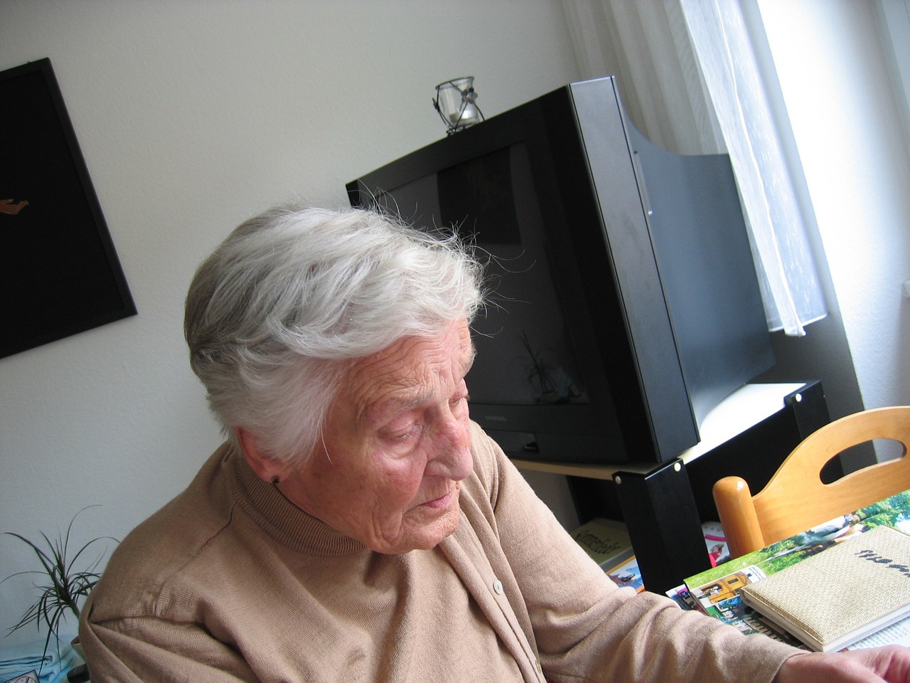 Older woman sitting in television room