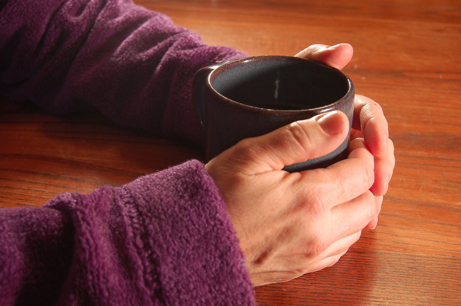 Hands holding a mug of tea, or maybe coffee, could even be hot chocolate!