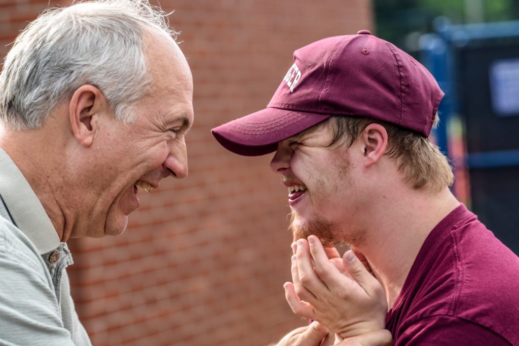 Two men laughing together