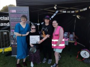 a group of Gig Buddies standing infront of a stall promoting Gig Buddies