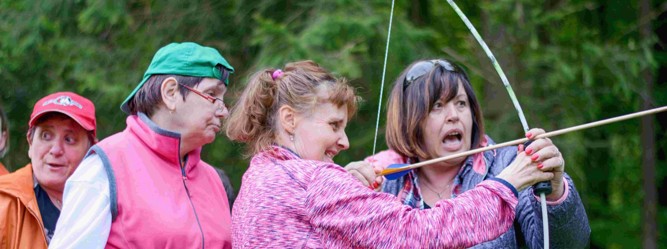 A group of people in an archery lesson