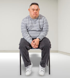 unhappy young man sitting on a chair