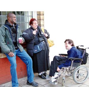 friends hanging out together, 1 of them is in a wheelchair