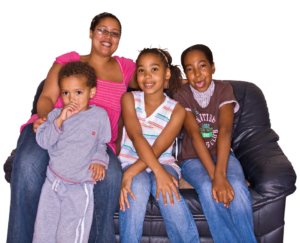 A woman and three children sat on a sofa