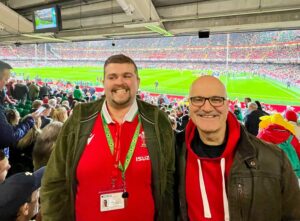 a pair of gig buddy friends watching a rugby match at the Principality Stadium