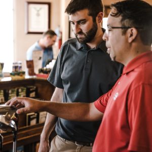 Two men choosing golf clubs