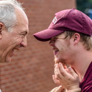 Two men laughing together