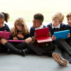 Group of primary school age children sitting together on the floor