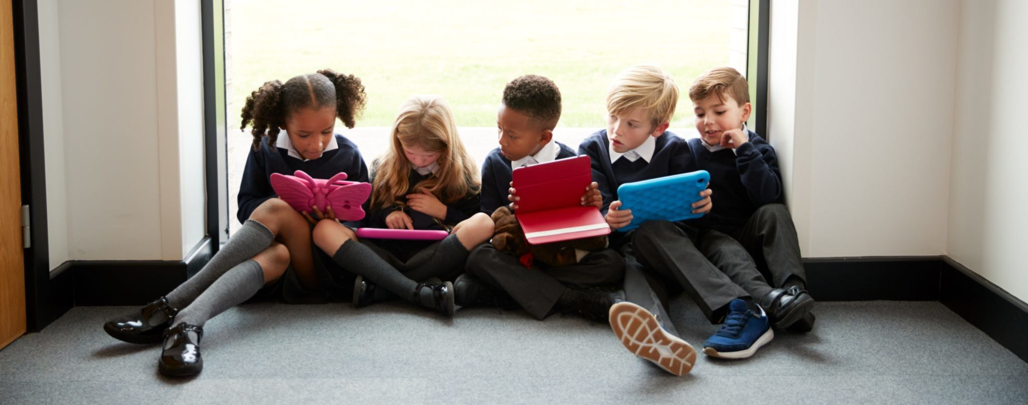 Group of primary school age children sitting together on the floor