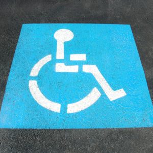 Disabled parking space sign painted on tarmac