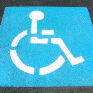 Disabled parking space sign painted on tarmac