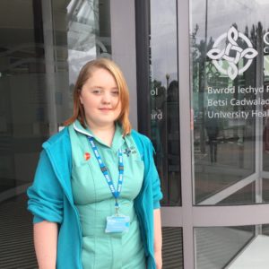 Young woman standing outside of her workplace