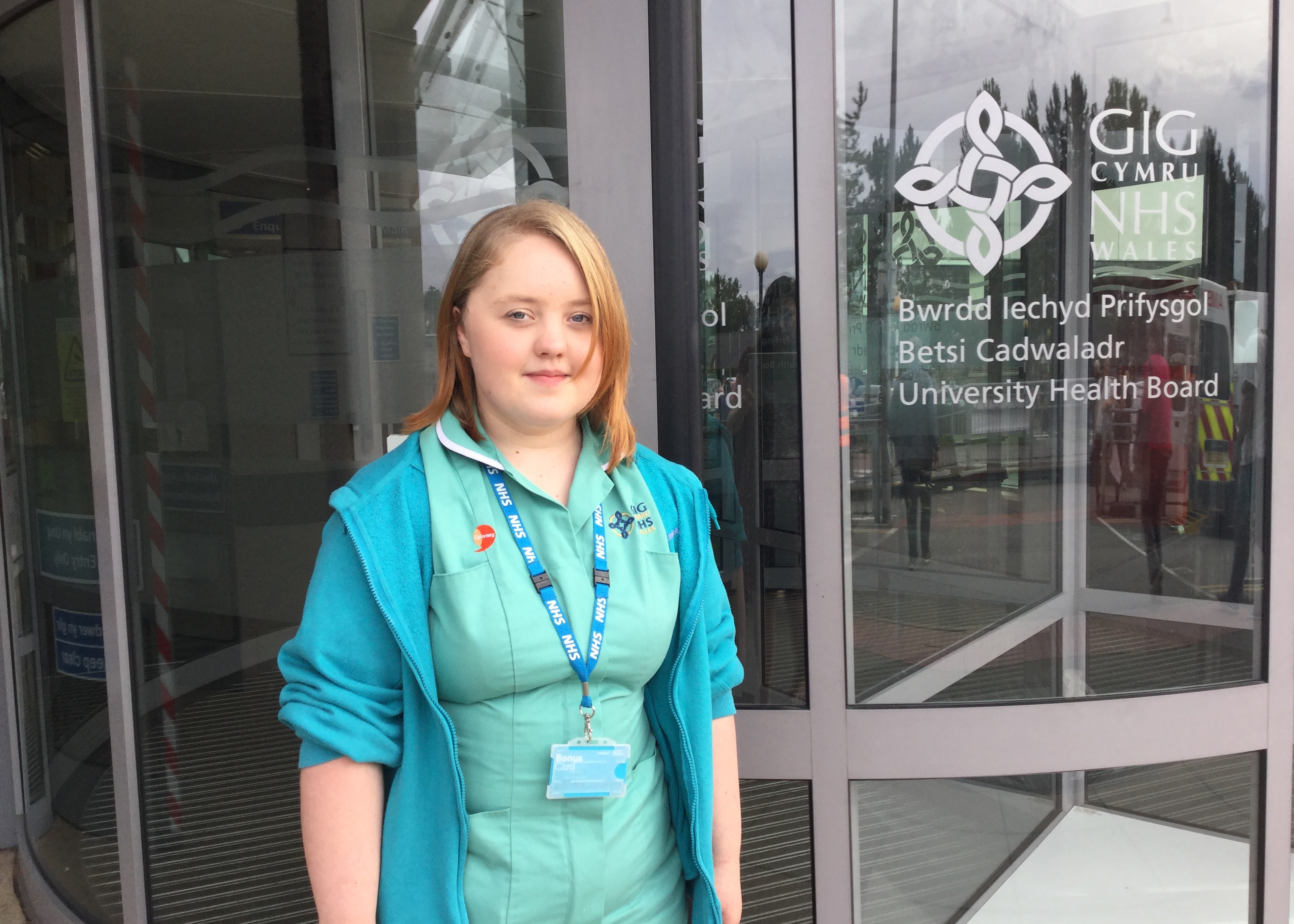 Young woman standing outside of her workplace