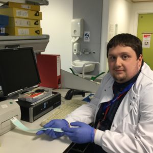 Young man in a white coat working in a laboratory