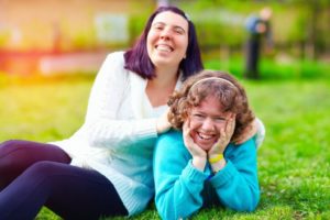 Two women are lying on the grass