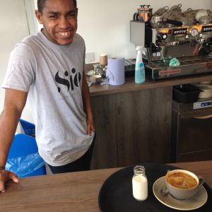 Young man working in a cafe