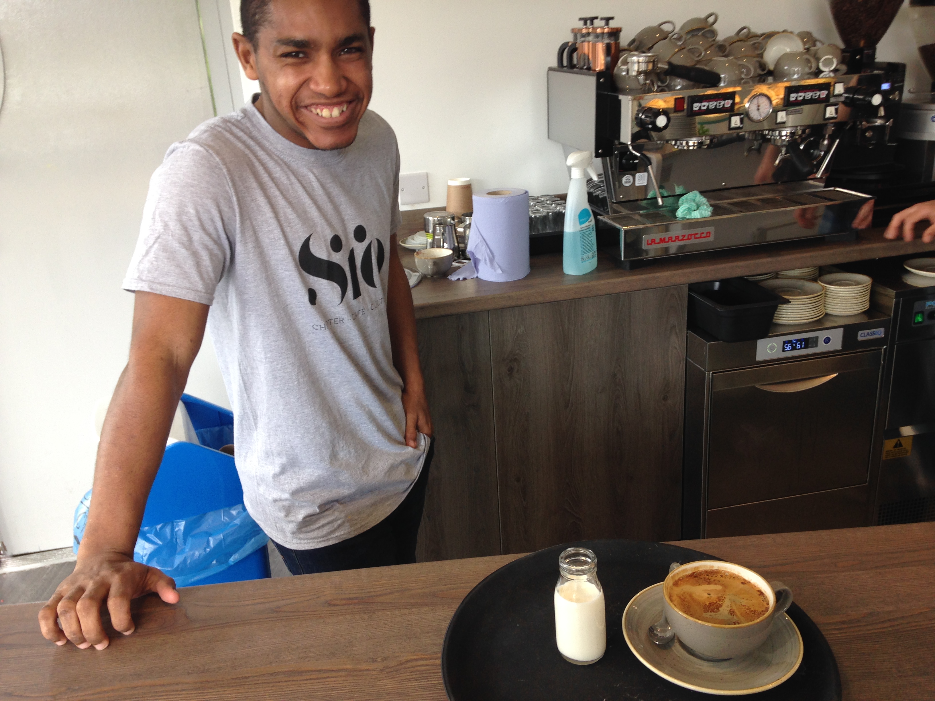 Young man working in a cafe