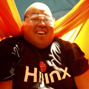 A man wearing a Hijinx logo t-shirt