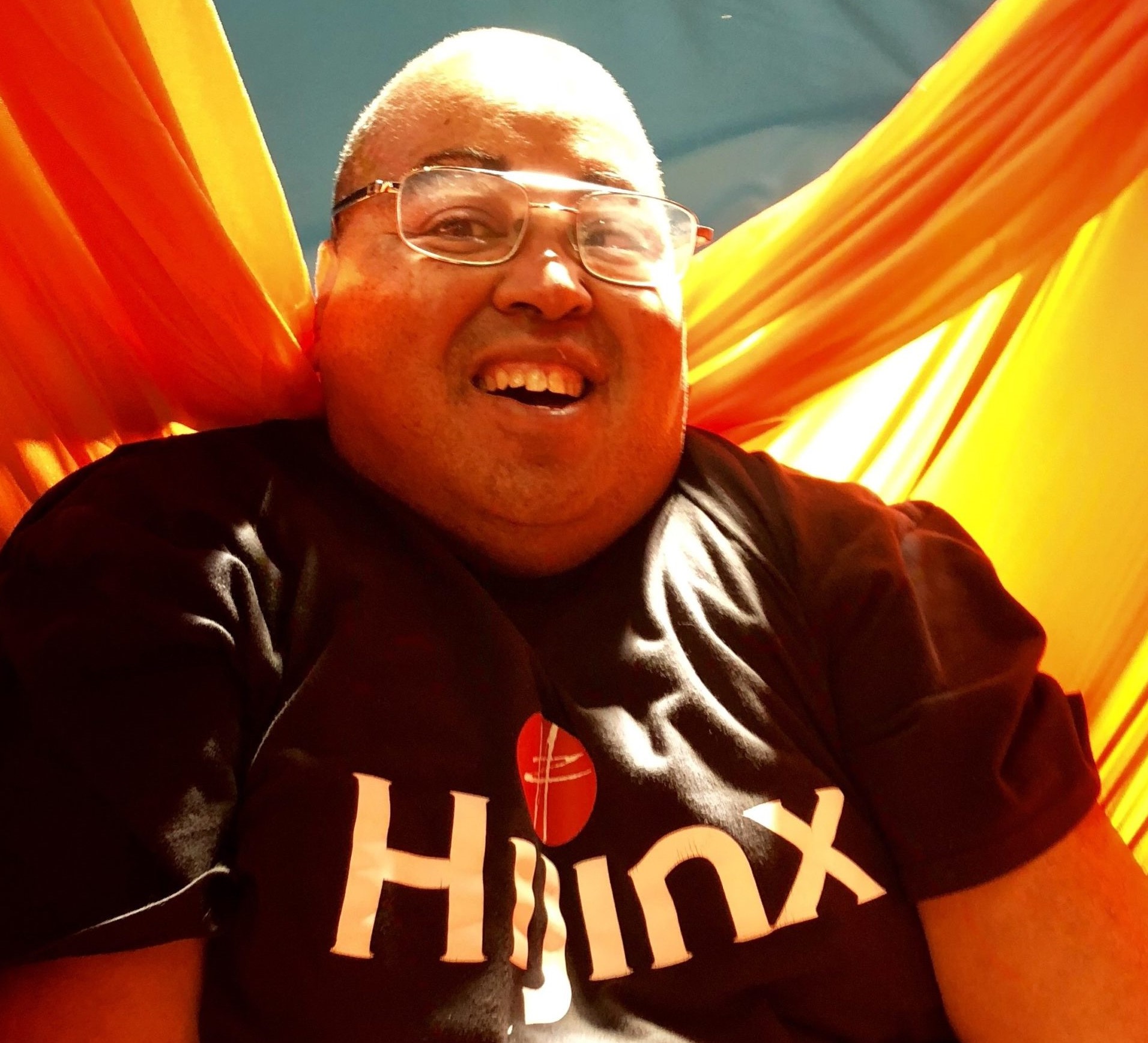 A man wearing a Hijinx logo t-shirt