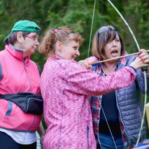A group of people in an archery lesson